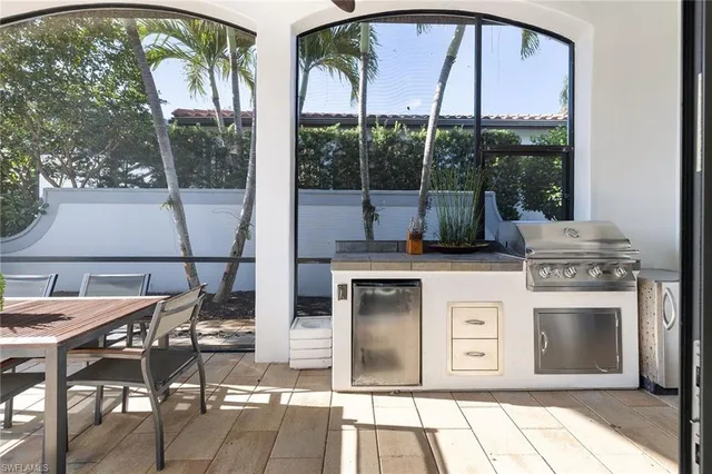 a kitchen with stainless steel appliances granite countertop a stove a sink and a dining table with granite countertops