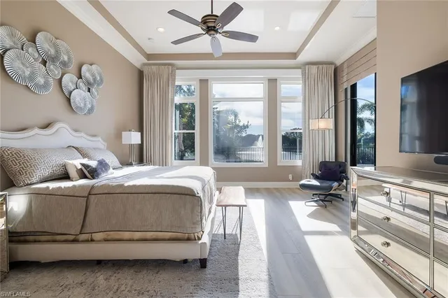 a bedroom with a bed and a large window with the garden view