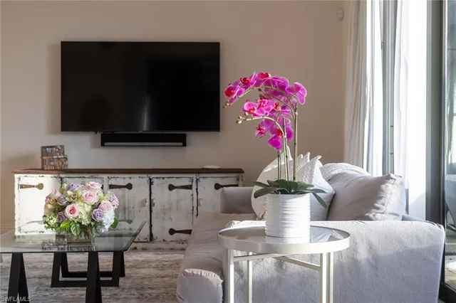 a dining room with furniture and flowers