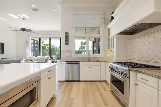 a kitchen with a stove top oven sink and cabinets