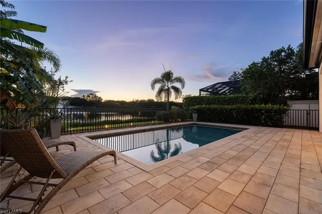 a view of a patio with swimming pool table and chairs