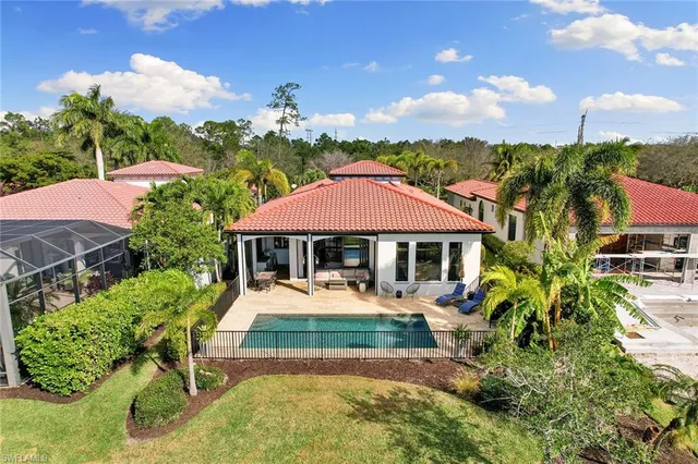 an aerial view of residential houses with outdoor space and lake view