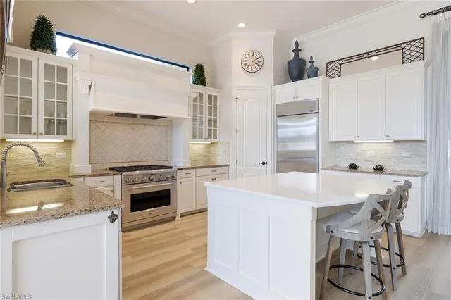 a kitchen with stainless steel appliances a stove a sink dishwasher and a refrigerator
