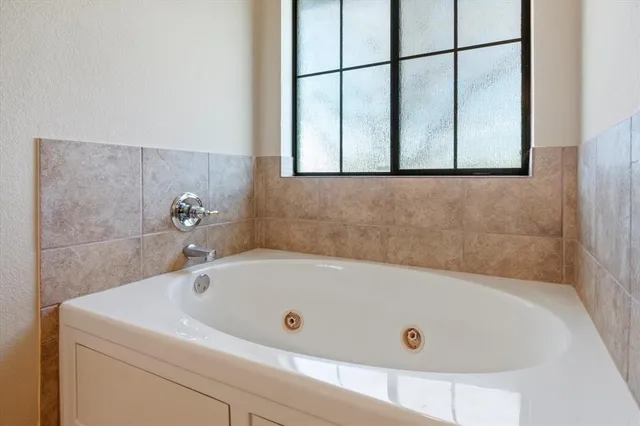 a bathroom with a tub and a shower