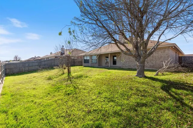 a view of a fountain with tree in front of it