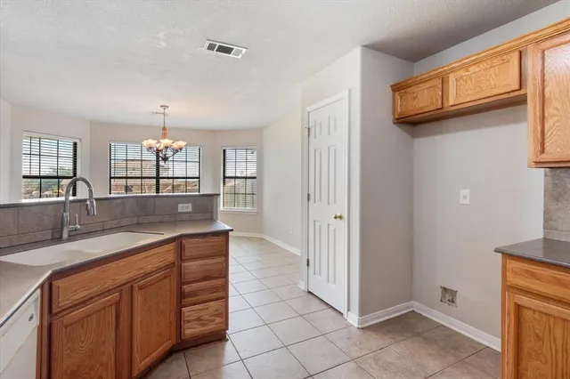 a kitchen with stainless steel appliances granite countertop a sink and a refrigerator