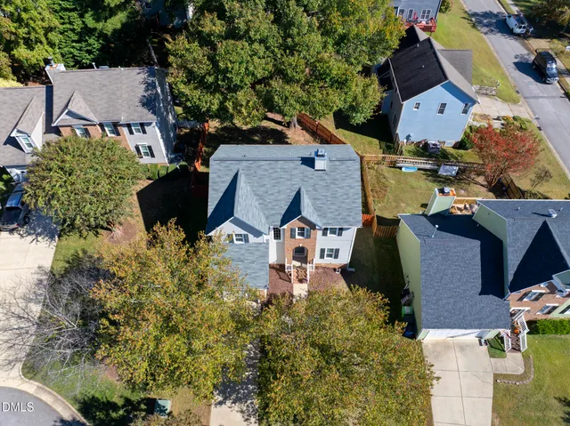 an aerial view of multiple houses with yard