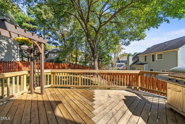 a view of balcony with wooden floor and fence