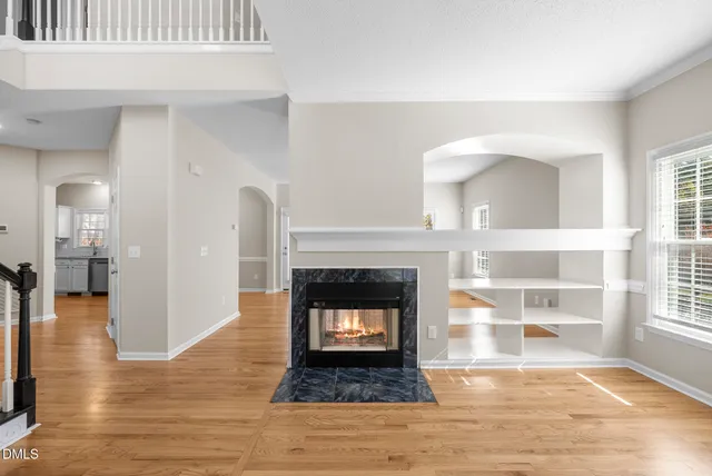 a living room with a fireplace and a rug