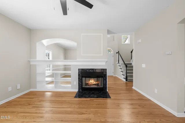 a view of a livingroom with a fireplace and cabinet