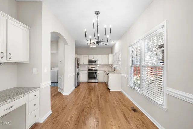 a view of a kitchen from the hallway