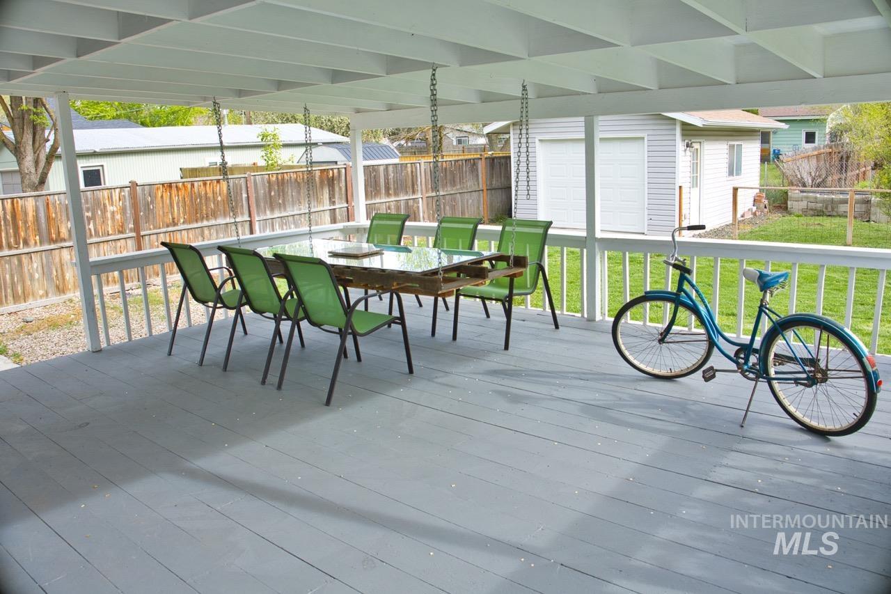 2223 West Spaulding Street Boise, ID 83705 - Photo 32 of 50 Wooden terrace featuring an outbuilding, a fenced backyard, and outdoor dining space
