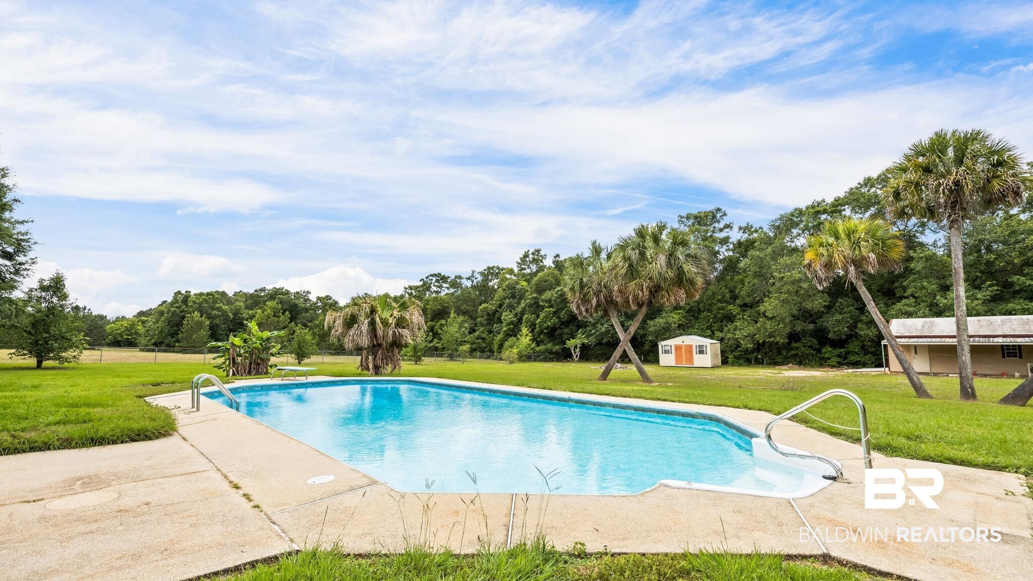 15096 Highland Circle Foley, AL 36535 - Photo 7 of 52 Rectangular in-ground pool with concrete surround