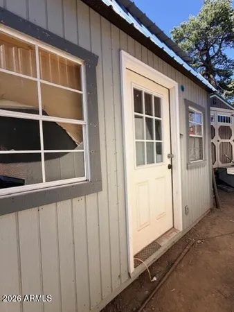 a view of backyard of house with car parked