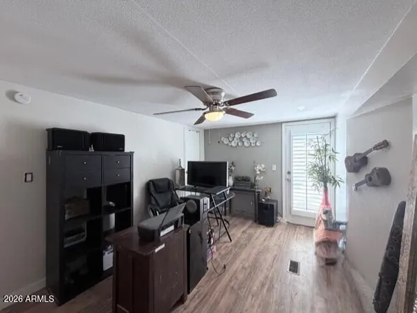 a view of a workspace with furniture and a window