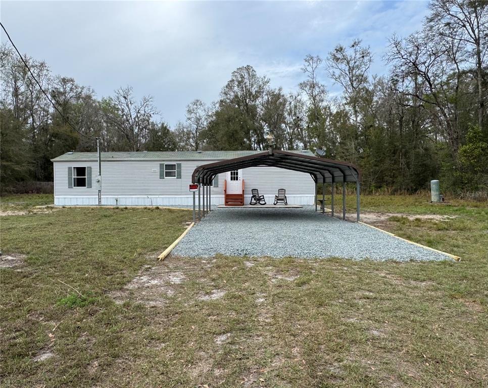 4317 284th Street Branford, FL 32008 - Photo 12 of 45 a view of a white house with a yard and fence
