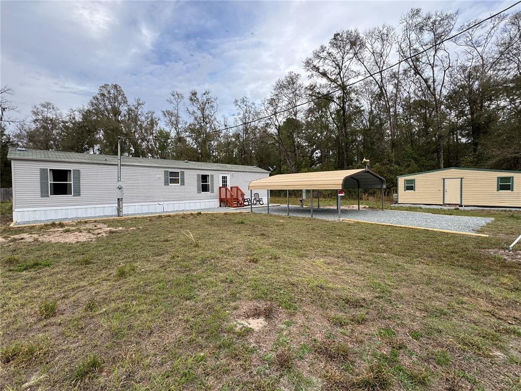 4317 284th Street Branford, FL 32008 - Photo 13 of 45 a view of a house with large trees and outdoor space