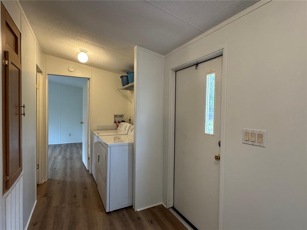 4317 284th Street Branford, FL 32008 - Photo 36 of 45 a view of a hallway with wooden floor and a bathroom