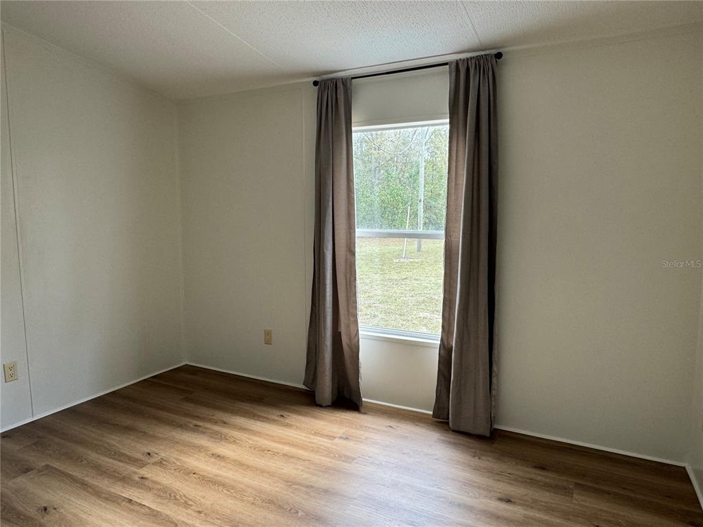 4317 284th Street Branford, FL 32008 - Photo 41 of 45 a view of empty room with wooden floor and fan