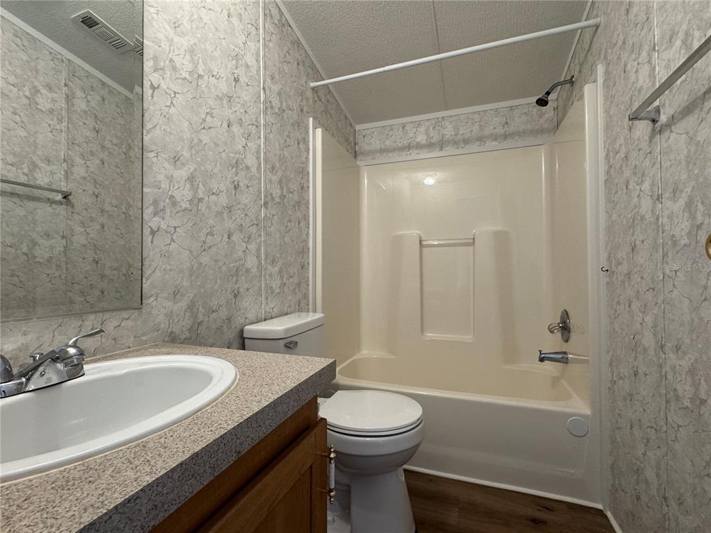 4317 284th Street Branford, FL 32008 - Photo 42 of 45 a bathroom with a granite countertop sink toilet and shower