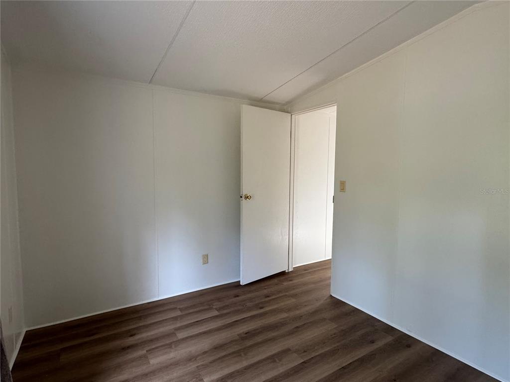 4317 284th Street Branford, FL 32008 - Photo 44 of 45 a view of an empty room with wooden floor