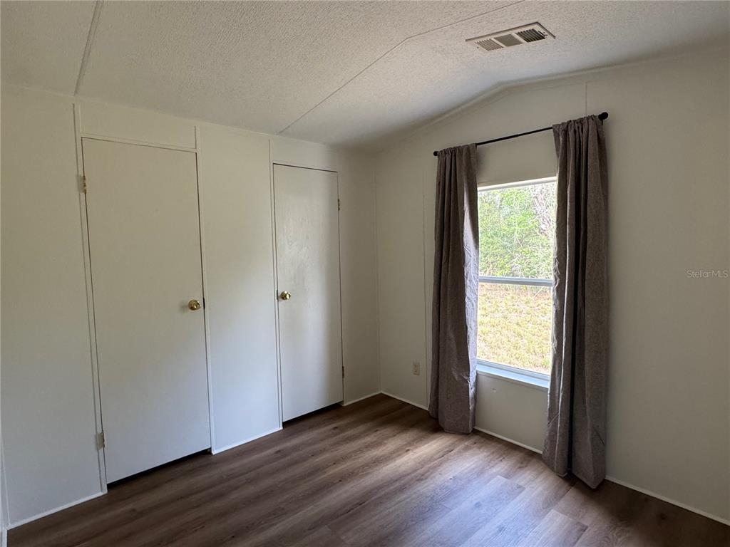 4317 284th Street Branford, FL 32008 - Photo 45 of 45 a view of an empty room with wooden floor and a window