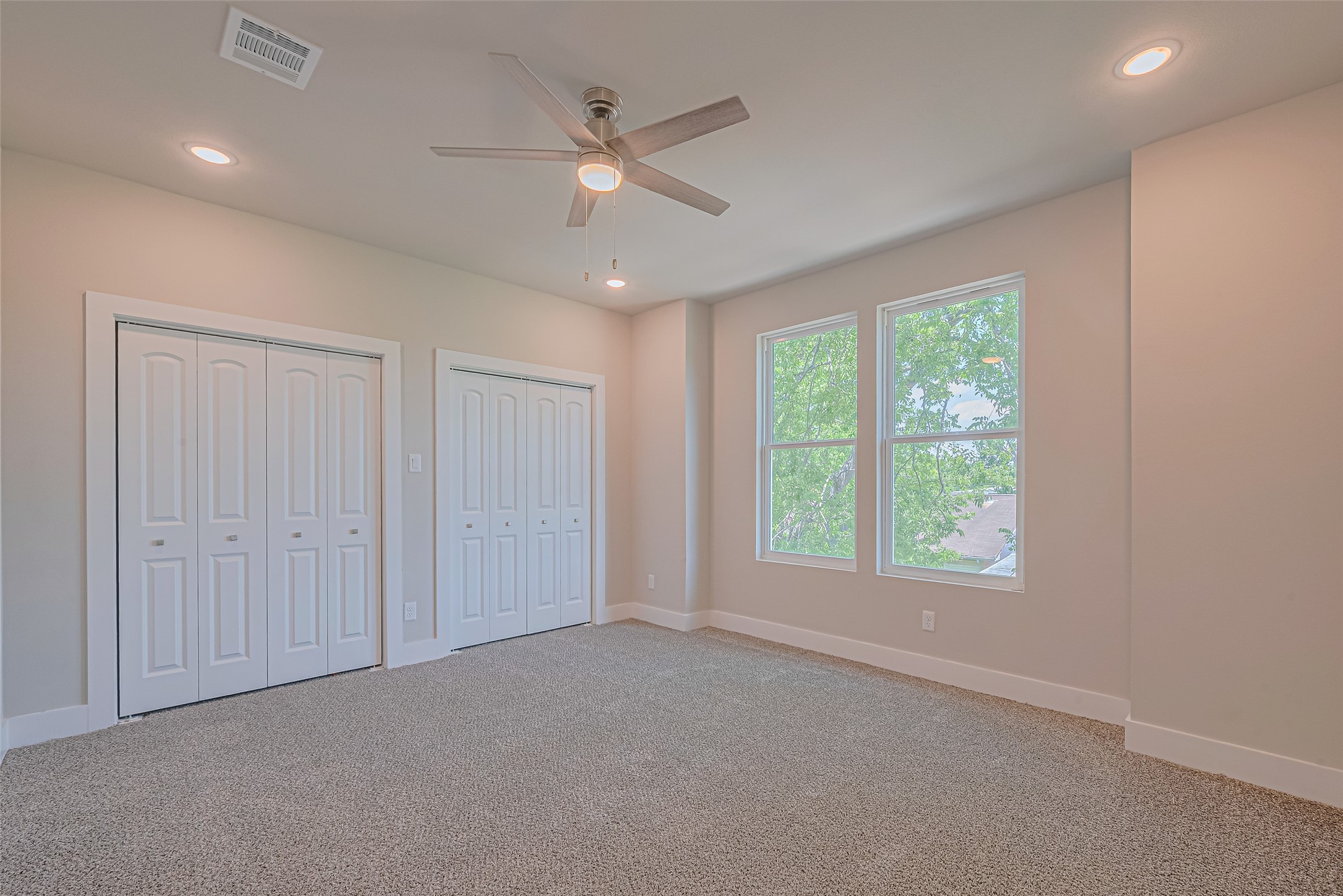 2414 Sam Wilson Street Houston, TX 77020 - Photo 12 of 29 an empty room with windows and fan