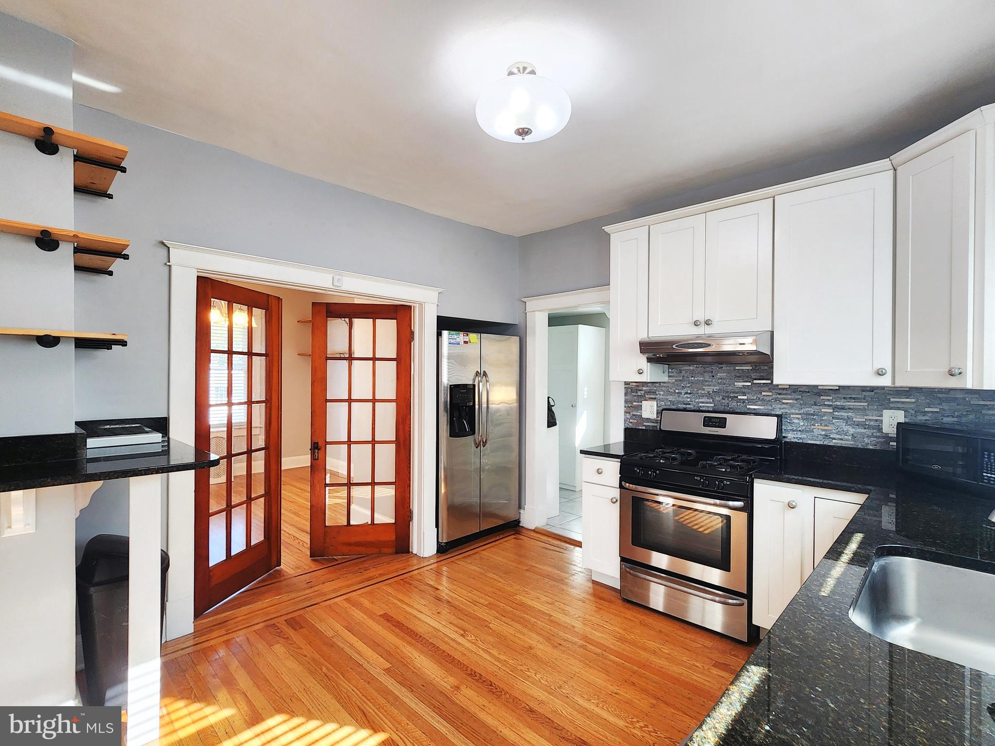 615 Old Home Road Baltimore, MD 21206 - Photo 12 of 31 a kitchen with stainless steel appliances granite countertop a stove a sink and a refrigerator