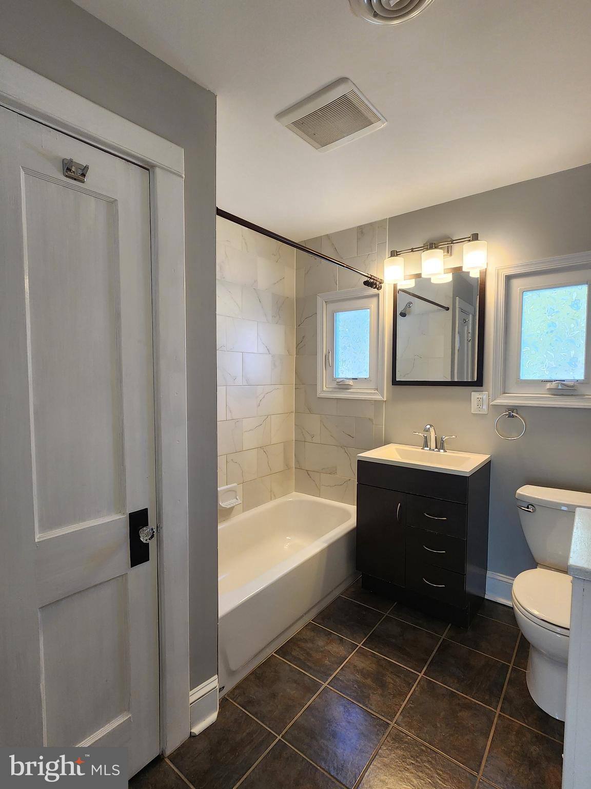 615 Old Home Road Baltimore, MD 21206 - Photo 23 of 31 a bathroom with a sink a toilet a mirror and shower