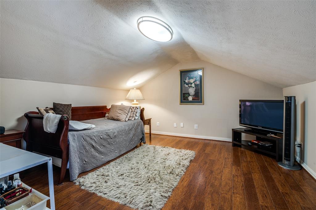 4559 North O'Connor Road, Unit 2289 Irving, TX 75062 - Photo 11 of 23 Room featuring a textured ceiling, wood finished floors, lofted ceiling, and baseboards. Open to your imagination