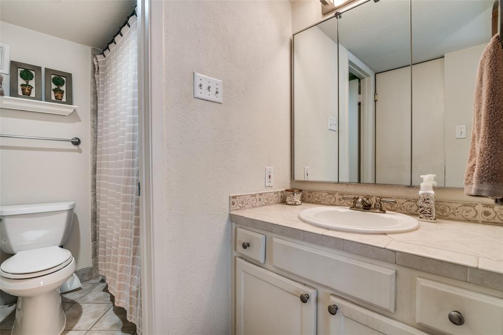 4559 North O'Connor Road, Unit 2289 Irving, TX 75062 - Photo 13 of 23 Primary bedroom's 1st floor bathroom featuring toilet, vanity, and tile patterned floors