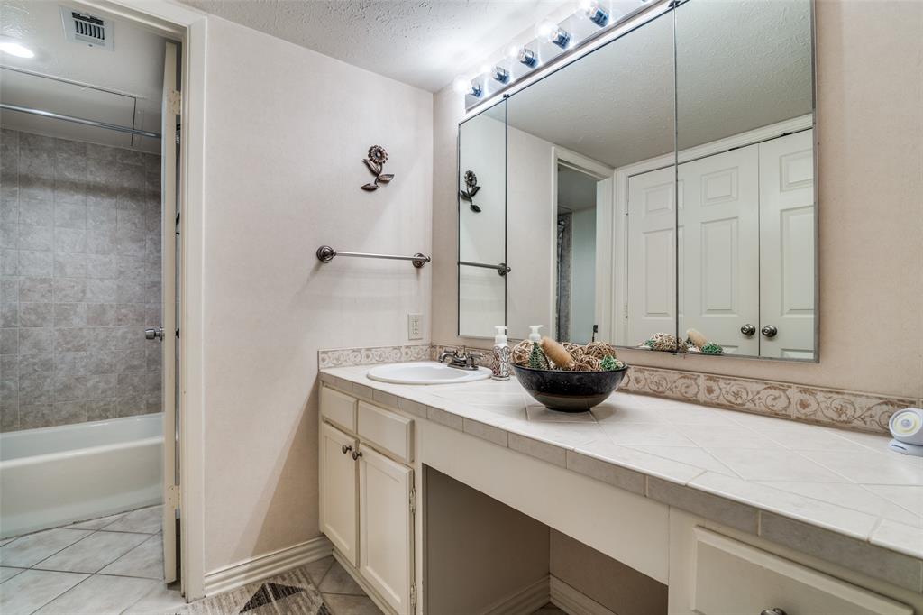 4559 North O'Connor Road, Unit 2289 Irving, TX 75062 - Photo 15 of 23 Full hallway bathroom with vanity, tile patterned floors, and baseboards. Across is your washer/dryer closet