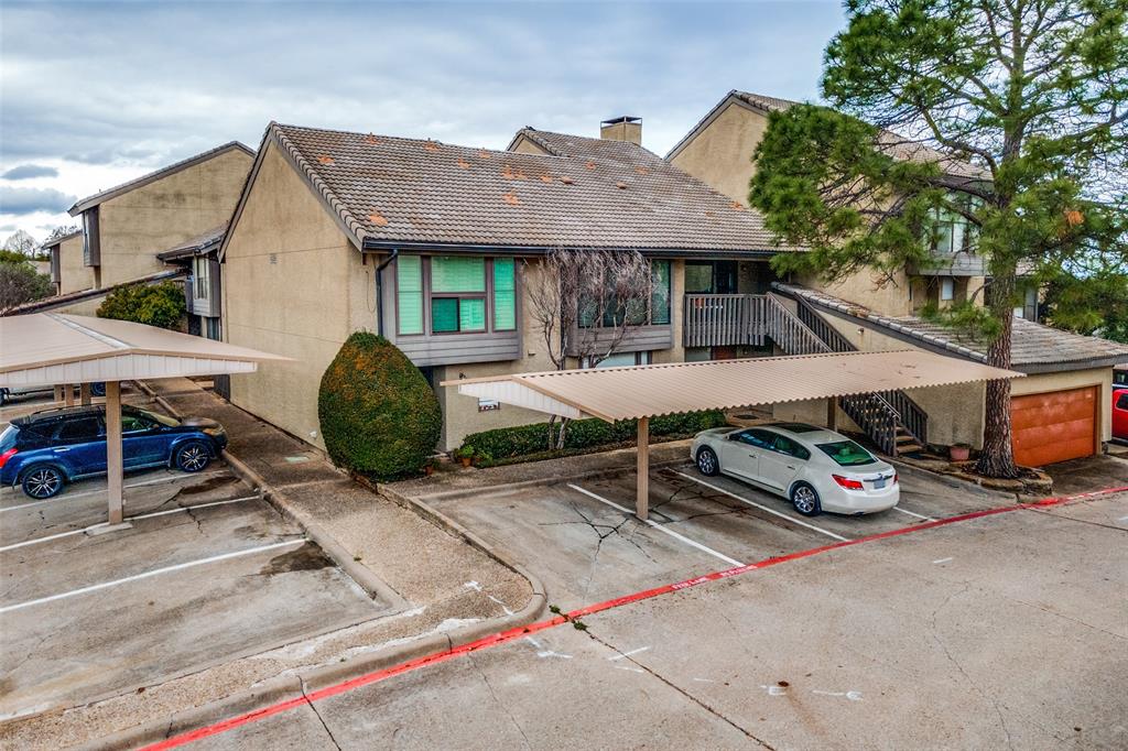 4559 North O'Connor Road, Unit 2289 Irving, TX 75062 - Photo 17 of 23 View of front of home and your covered parking, a chimney, stucco siding, and stairway