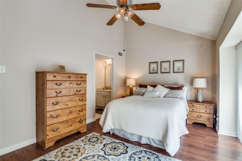 4559 North O'Connor Road, Unit 2289 Irving, TX 75062 - Photo 7 of 23 Primary 2nd floor bedroom with dark wood-style flooring, crown molding, baseboards, connected bathroom, and high vaulted ceiling