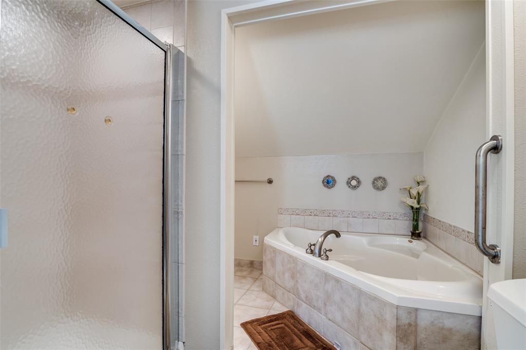 4559 North O'Connor Road, Unit 2289 Irving, TX 75062 - Photo 9 of 23 Primary 2nd floor bathroom with a shower stall, a bath, vaulted ceiling, and tile patterned floors