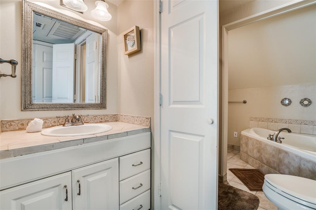 4559 North O'Connor Road, Unit 2289 Irving, TX 75062 - Photo 10 of 23 Jacuzzi, vanity, toilet,stand up shower and tile patterned flooring