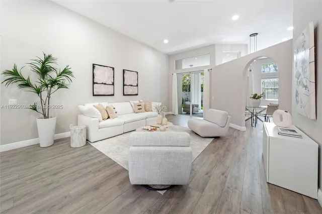 a living room with furniture and a large window