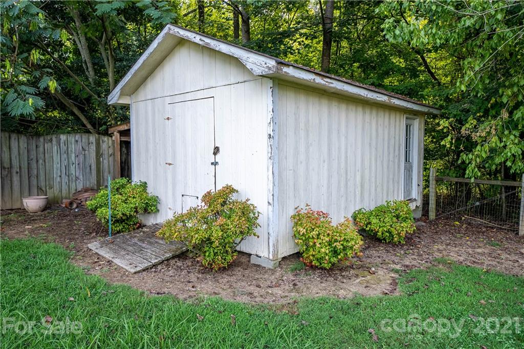8623 Smith Road Stanfield, NC 28163 - Photo 13 of 27 a view of a backyard with plants and a fence