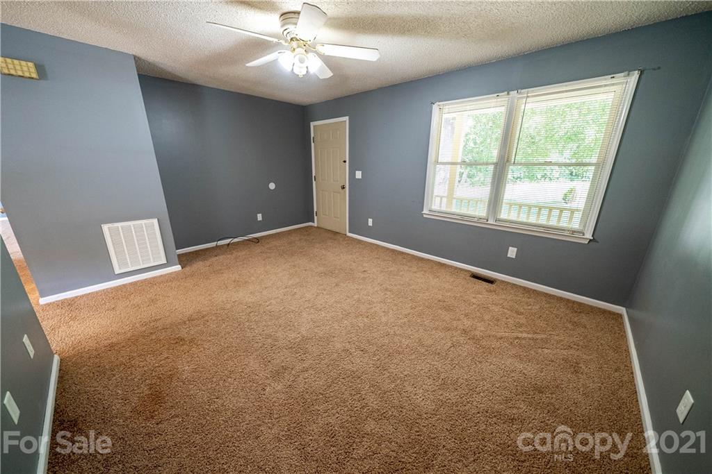 8623 Smith Road Stanfield, NC 28163 - Photo 15 of 27 a view of an empty room with a window