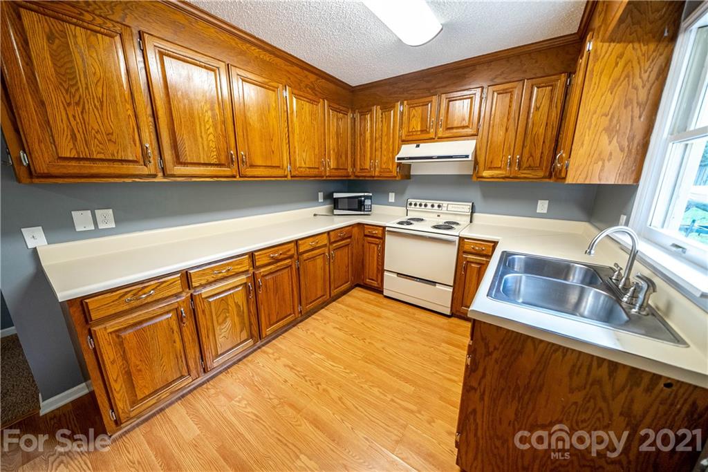 8623 Smith Road Stanfield, NC 28163 - Photo 16 of 27 a kitchen with granite countertop sink cabinets and window