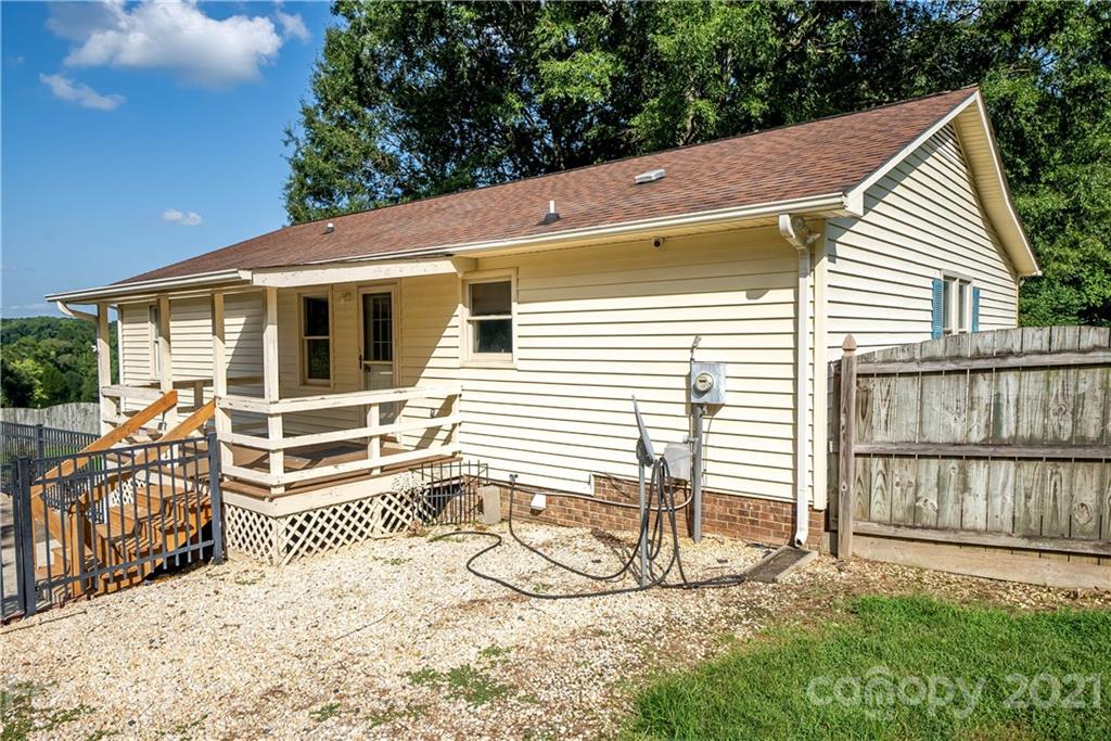 8623 Smith Road Stanfield, NC 28163 - Photo 3 of 27 a view of a house with a small yard and wooden fence