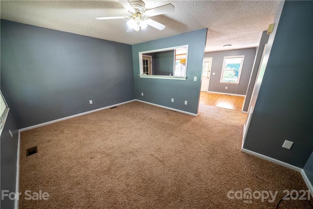 8623 Smith Road Stanfield, NC 28163 - Photo 21 of 27 an empty room with windows and fan