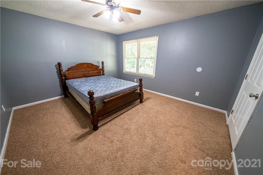 8623 Smith Road Stanfield, NC 28163 - Photo 24 of 27 a living room with furniture and a chandelier