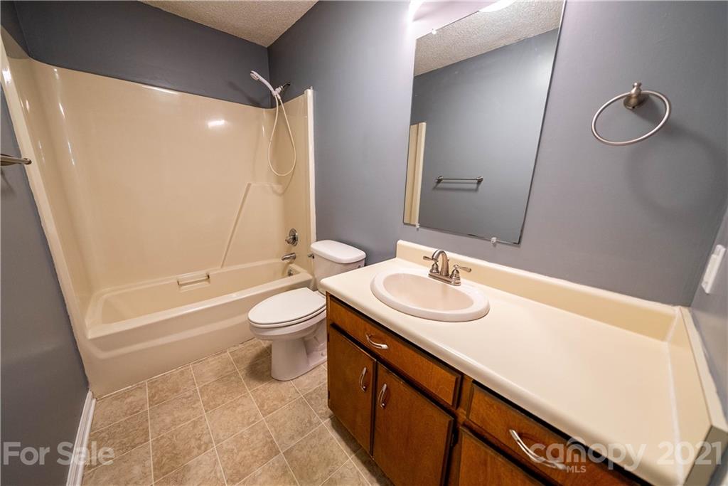 8623 Smith Road Stanfield, NC 28163 - Photo 25 of 27 a bathroom with a sink a toilet and shower