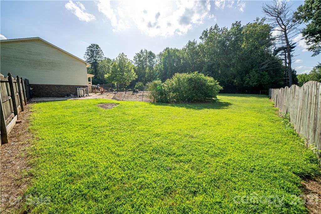 8623 Smith Road Stanfield, NC 28163 - Photo 8 of 27 a backyard of a house with lots of green space