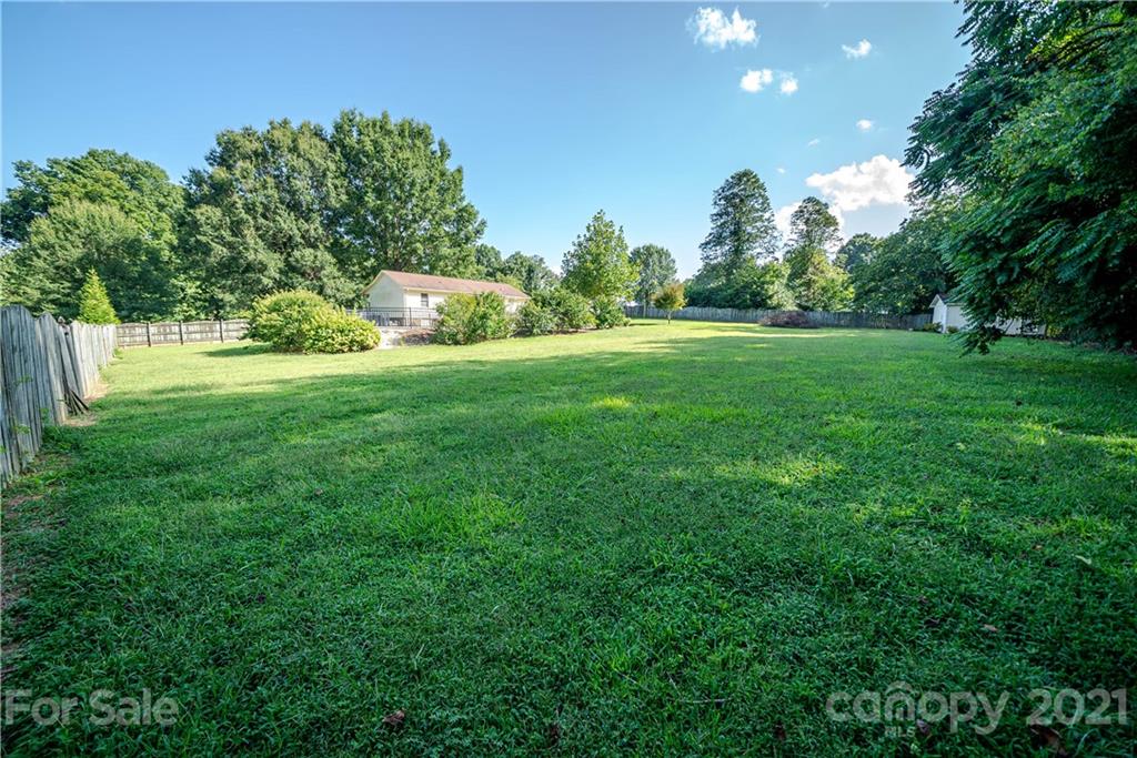 8623 Smith Road Stanfield, NC 28163 - Photo 10 of 27 a view of a grassy field with trees in the background