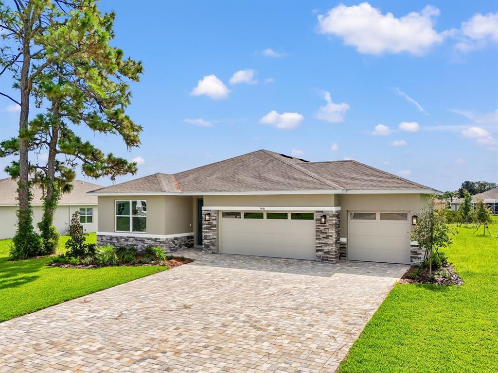 9196 Players Drive Weeki Wachee, FL 34613 - Photo 1 of 29 a front view of a house with a garden and yard