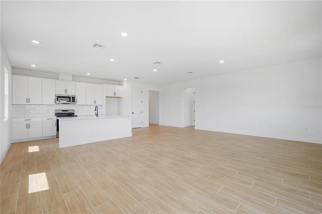 9196 Players Drive Weeki Wachee, FL 34613 - Photo 13 of 29 a view of kitchen with kitchen island white cabinets and refrigerator