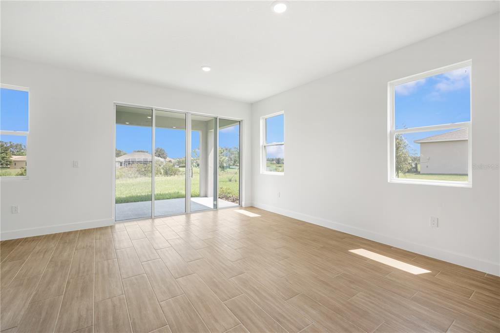 9196 Players Drive Weeki Wachee, FL 34613 - Photo 14 of 29 a view of an empty room with wooden floor and a window