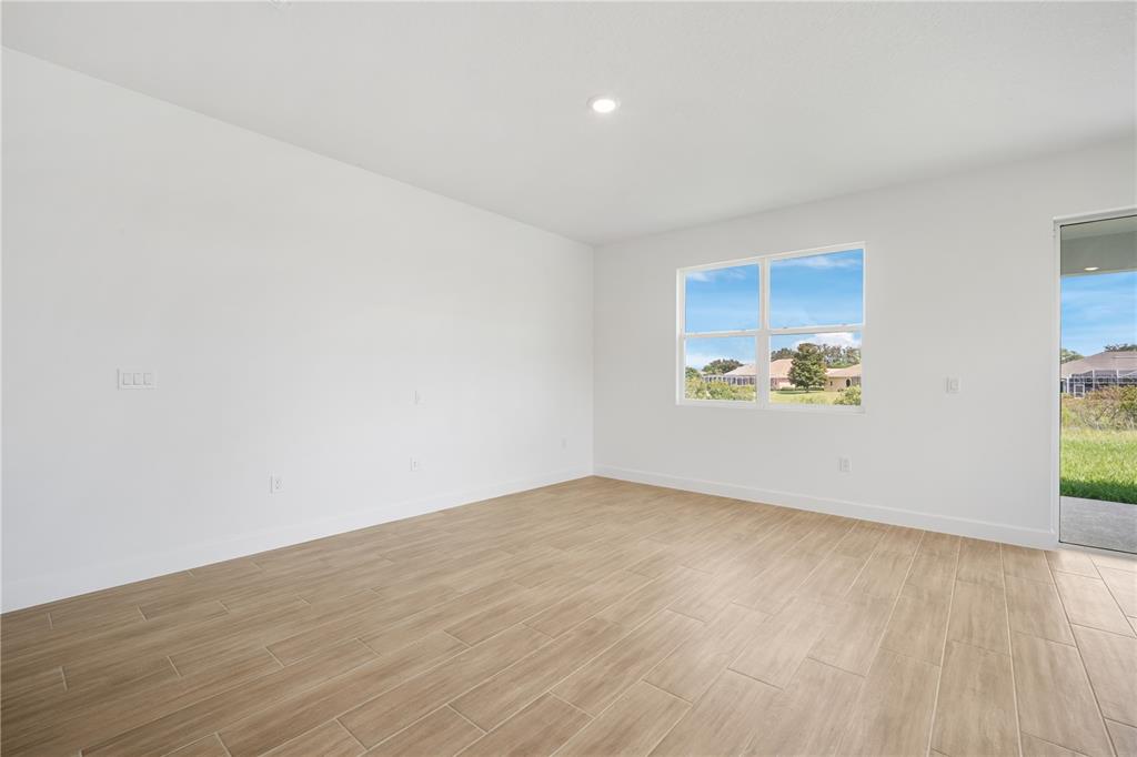 9196 Players Drive Weeki Wachee, FL 34613 - Photo 15 of 29 an empty room with wooden floor and window